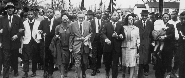 Group of people marching together in a civil rights demonstration.