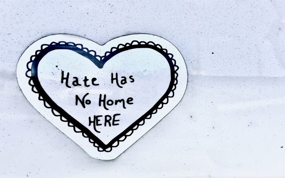 A paper heart with the words "Hate has no home here"