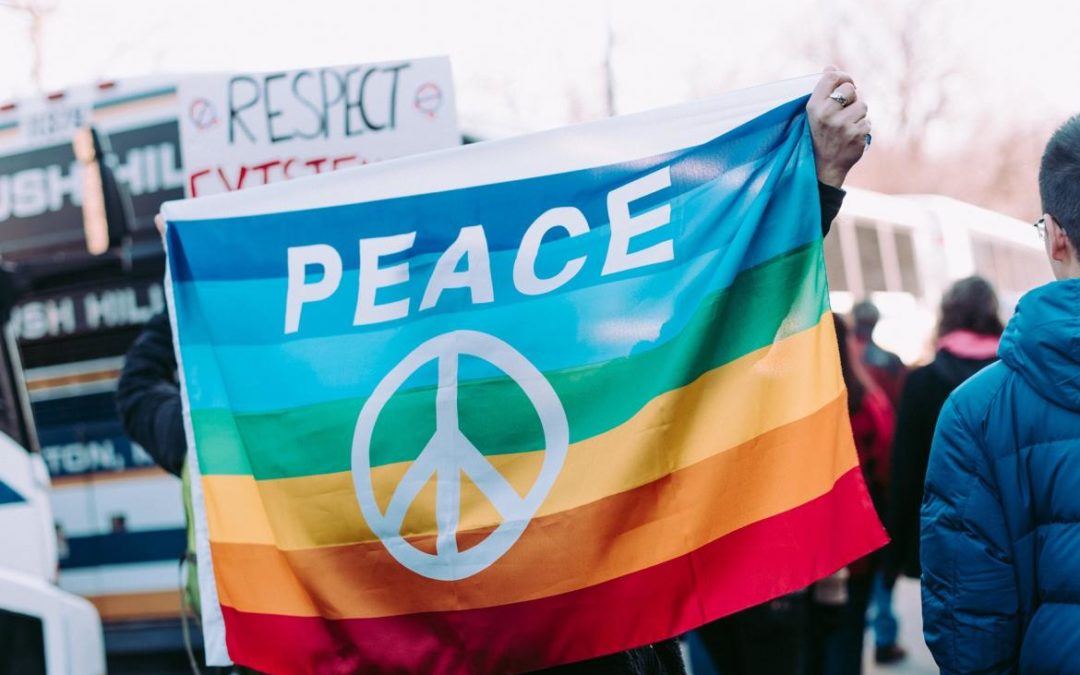 a group of people holding up a peace flag